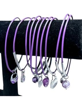 SET OF 10 PURPLE BRACELETS WITH SILVER TONE BARS AND CHARMS
